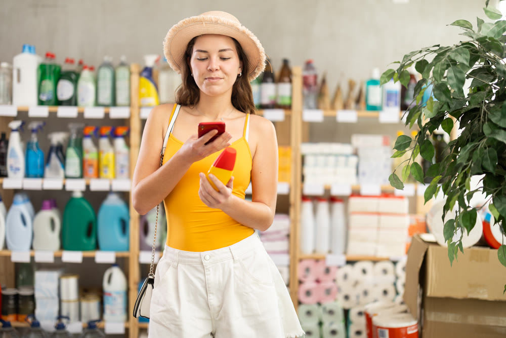 Girl buyer scans qr code on mosquito repellent label
