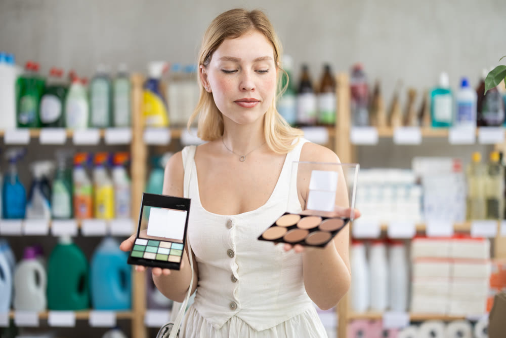 Happy woman chooses cosmetics in perfume hypermarket
