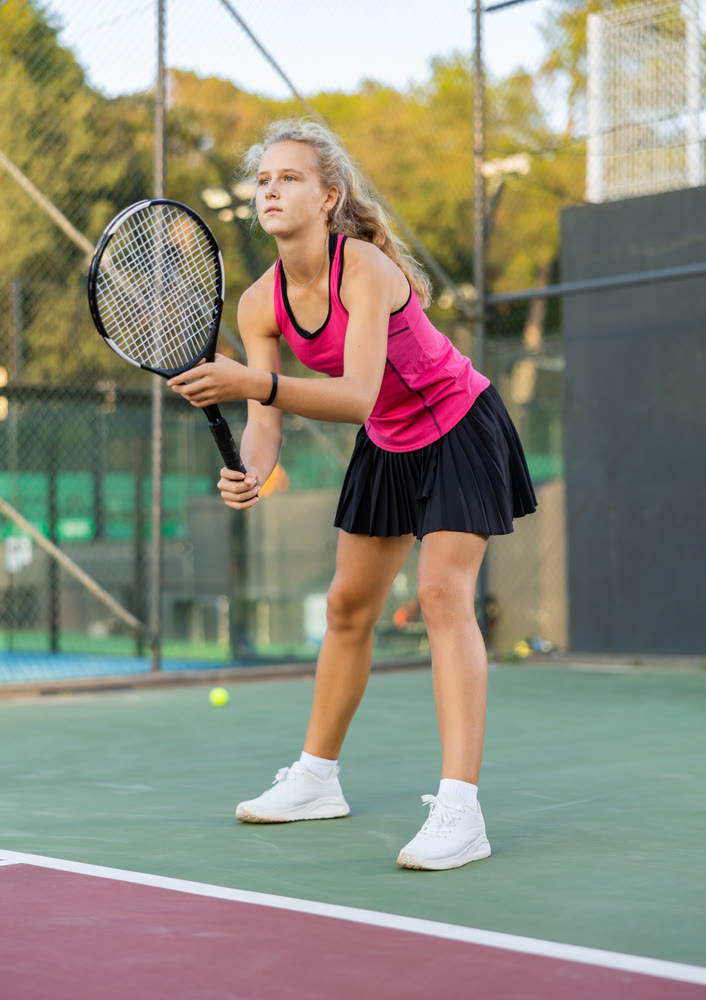 Woman tennis player training on court