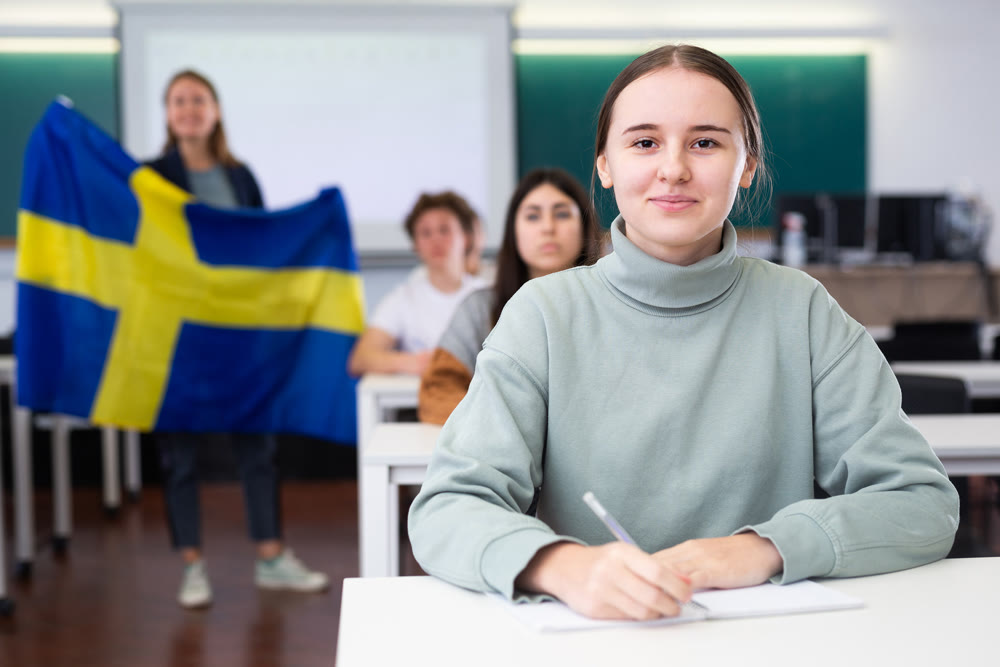 Young girl student diligently studies at school