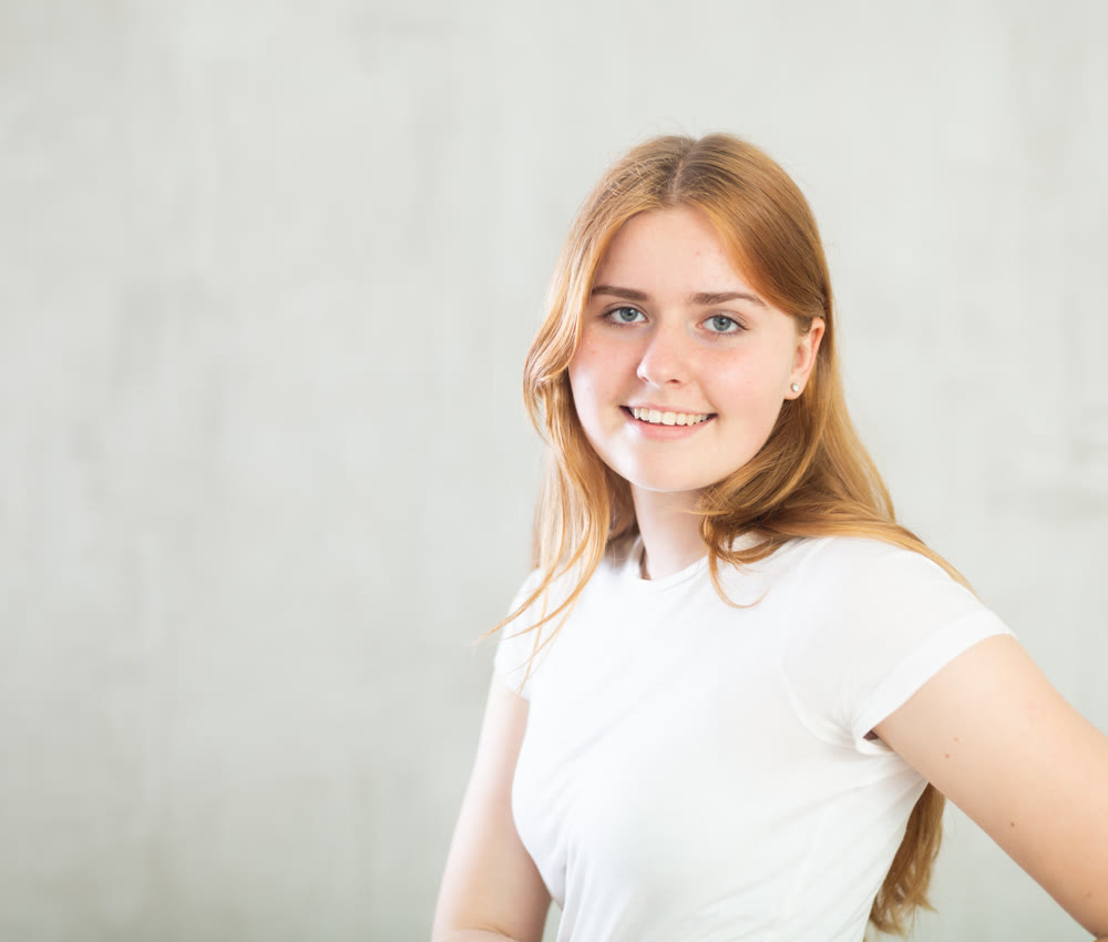 Portrait of young girl on grey background studio portrait