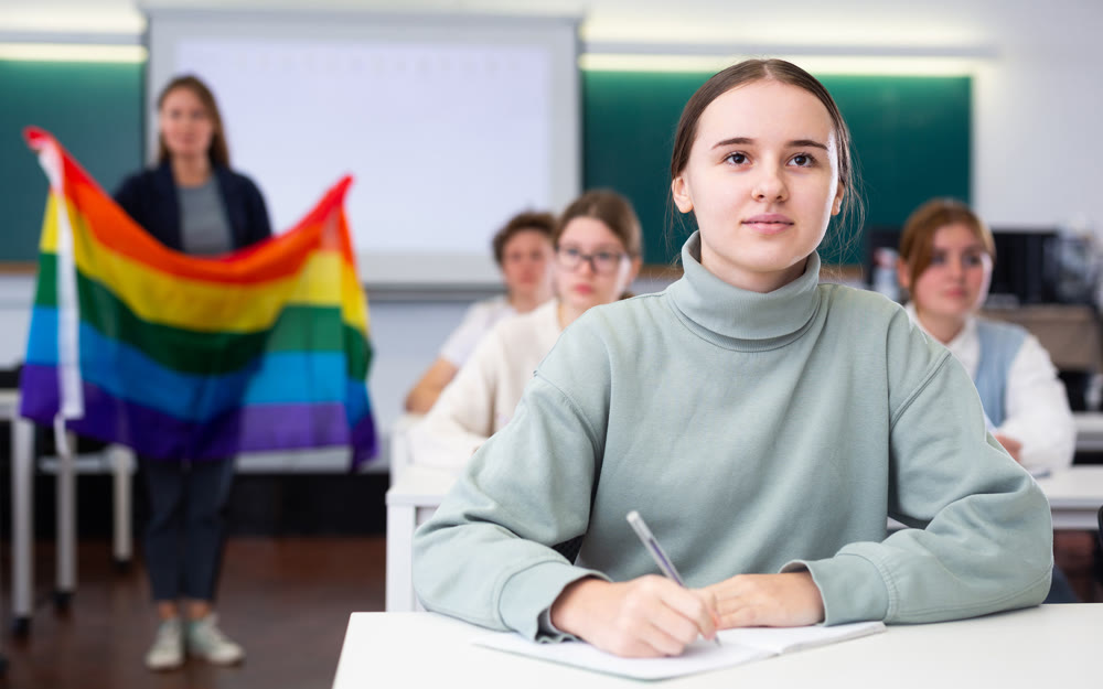 Young girl student diligently studies at school