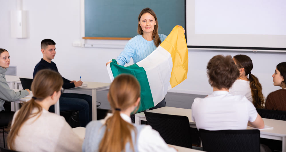 Female professor shows students flag of Ireland