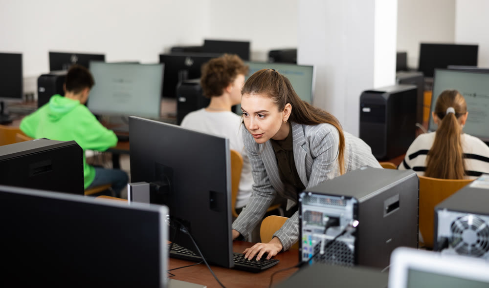 Interested young woman studying in university computer lab