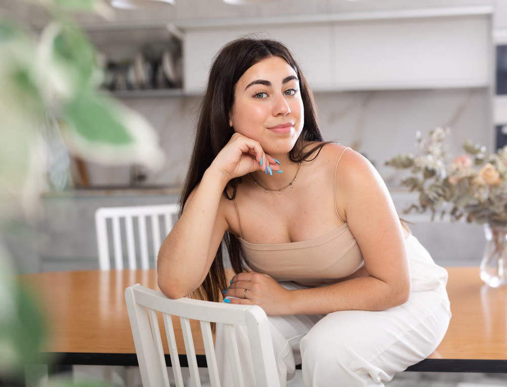 Young smiling woman posing in kitchen at home