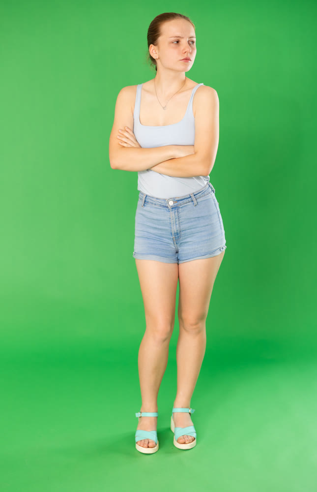 Sad teenage girl in front of green screen
