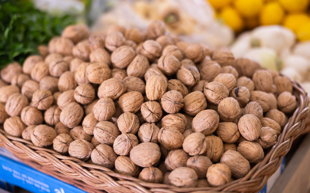 Walnuts in basket on shelf in greengrocery