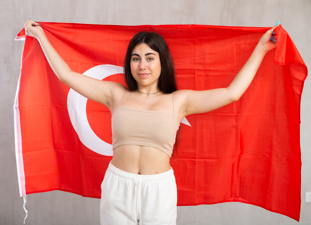 Young woman with Turkey flag posing in studio