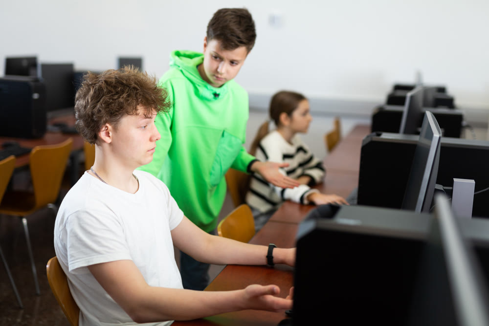 Portrait of guy working at computer in computer class at school
