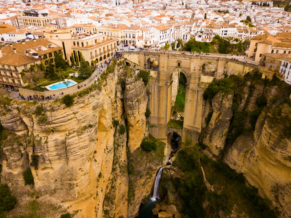 Rocky landscape of Ronda city with Puente Nuevo Bridge and buildings