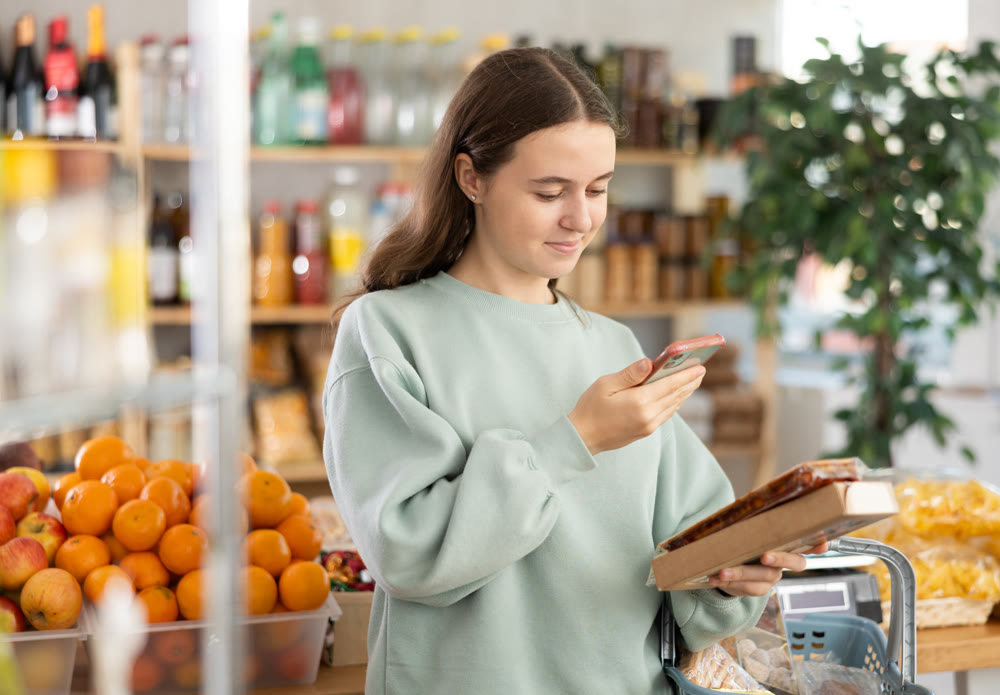 Teenage girl scanning qr code of nougat