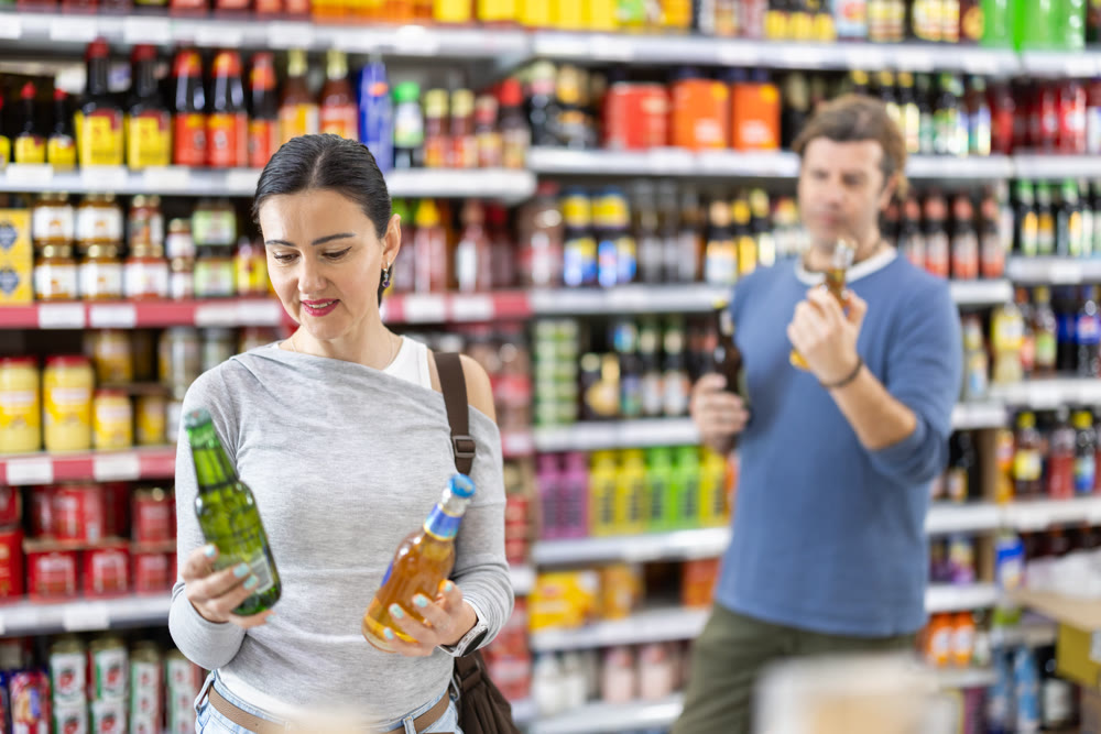 Woman in supermarket choose beer