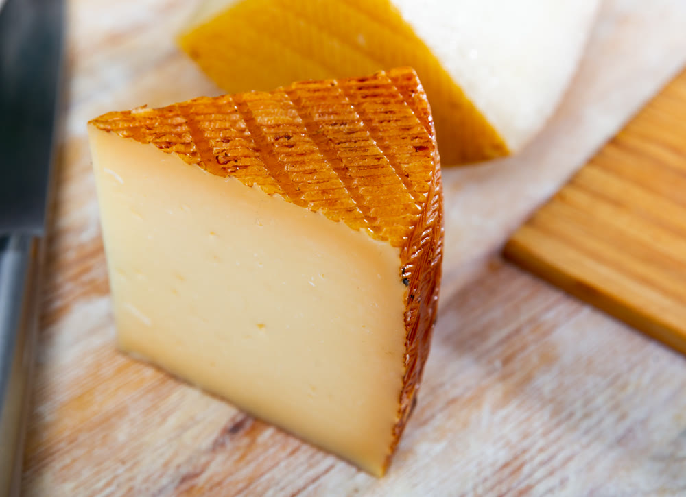 Slices of traditional spanish semi-hard cheese from milk of sheep