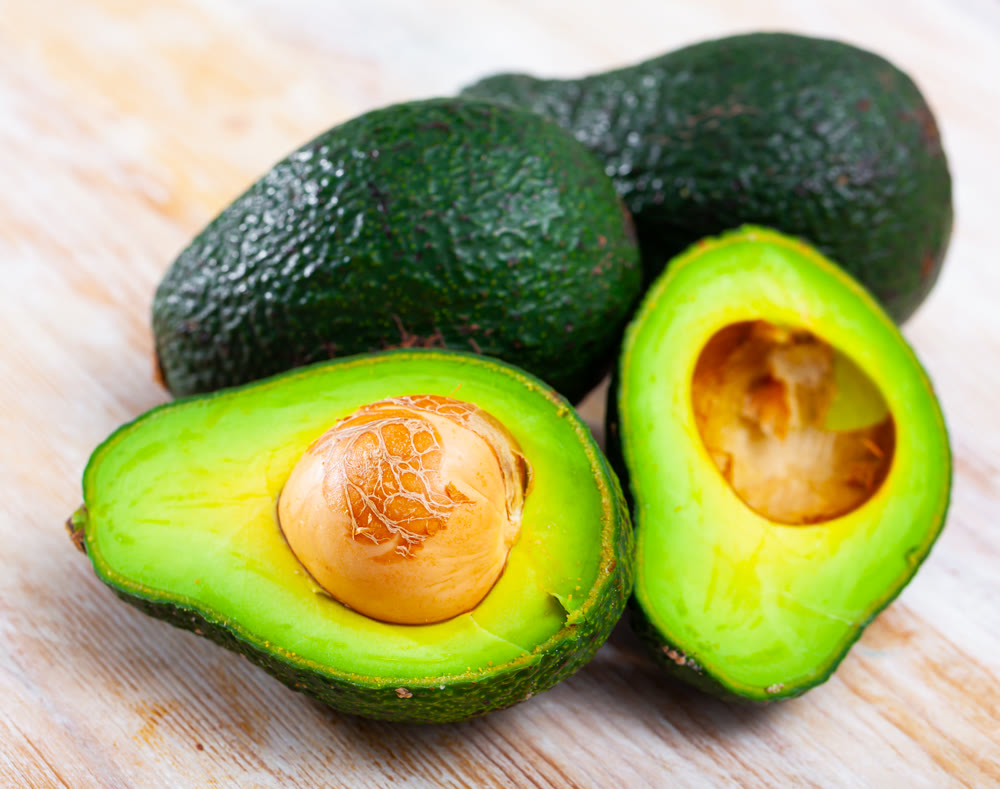 Tasty avocado on wooden surface