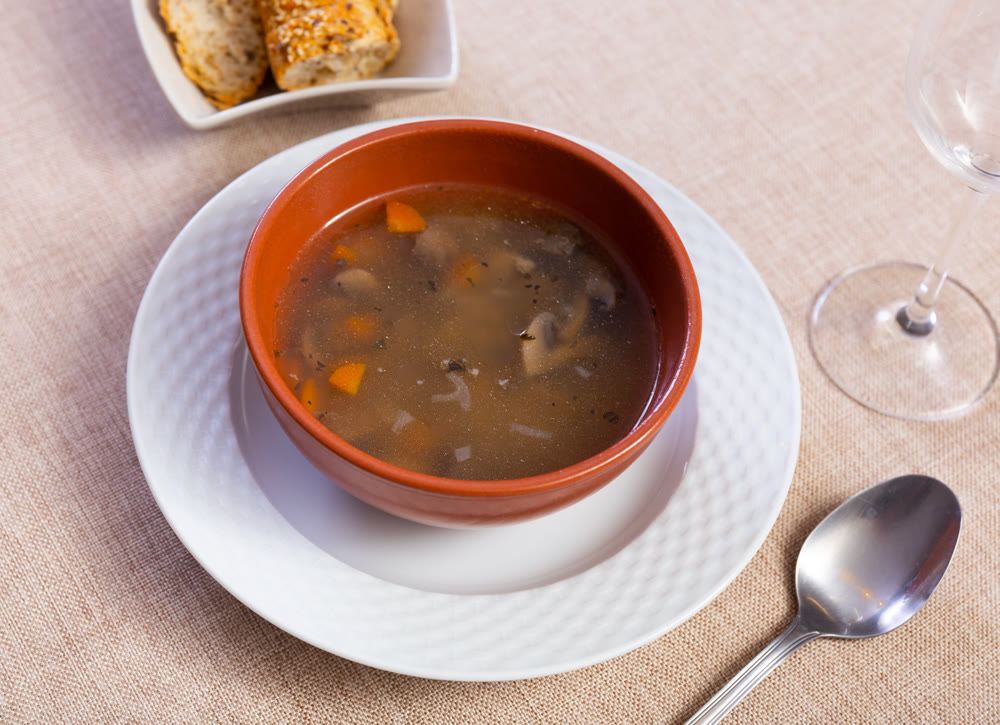 Homemade soup with mushrooms, pork, vegetables and pearl barley
