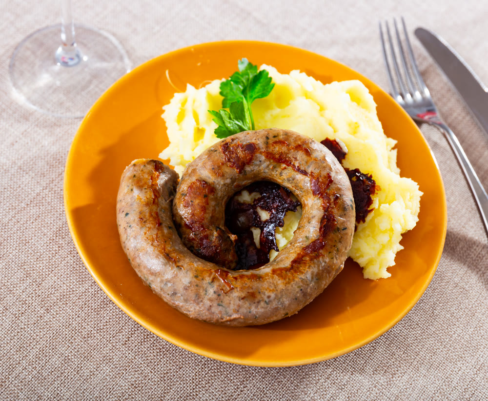 Mashed potatoes with sausage served on platter