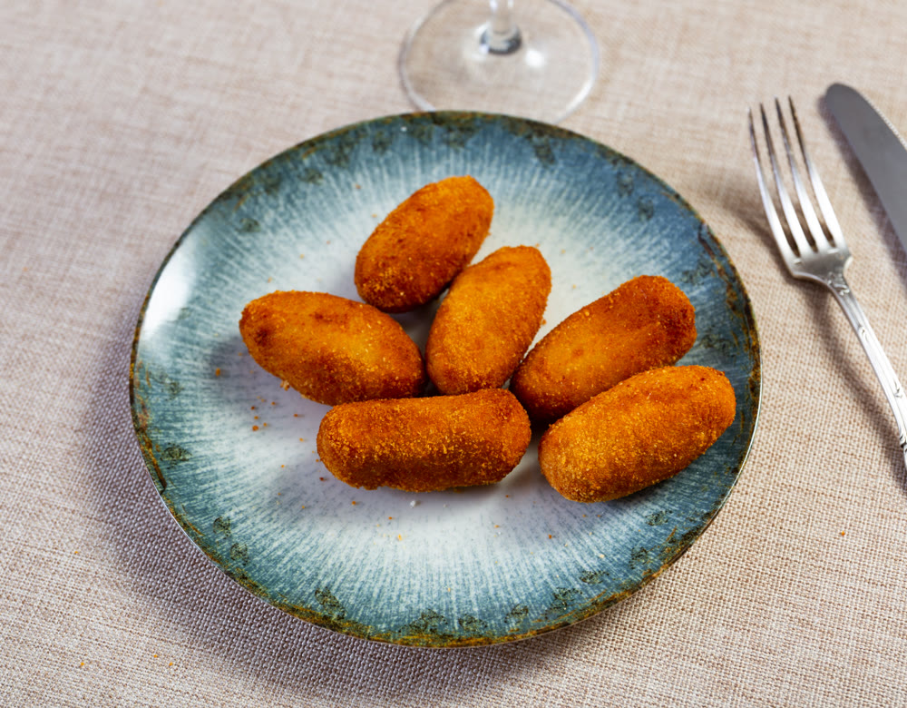 Crispy croquettes with filling served at table