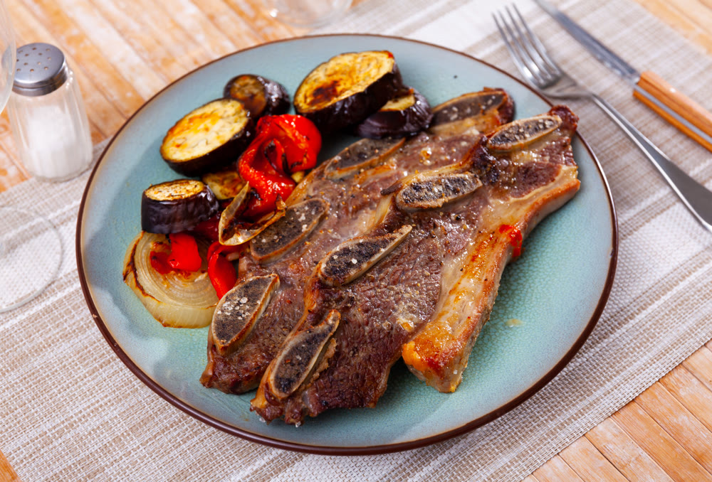 Delicious uruguayan style churrasco steak served with eggplant and pimento pepper