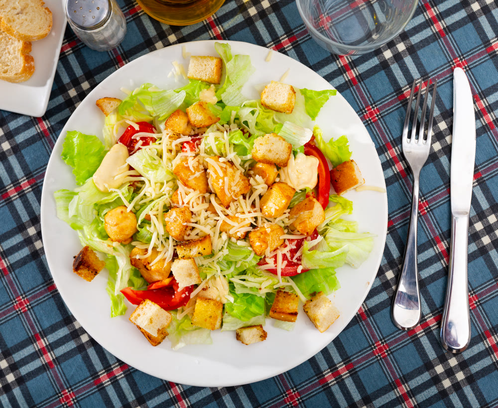 Caesar salad with tomatoes served in diner