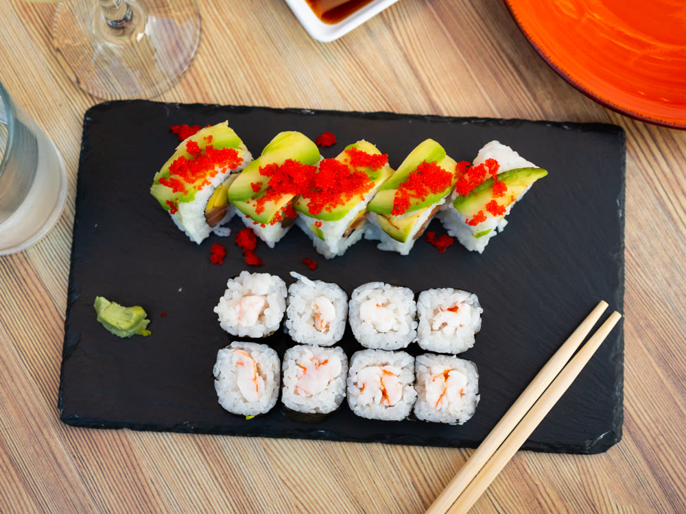 Set of different types of sushi served on board