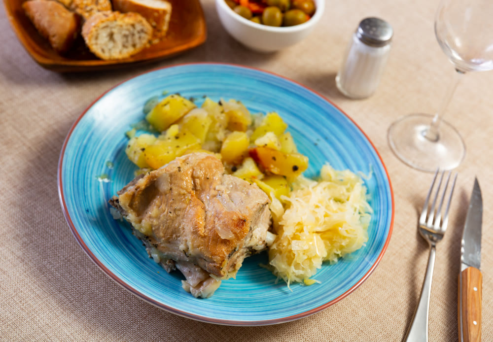 Delicious pork ribs with boiled potatoes and sauerkraut ccloseup