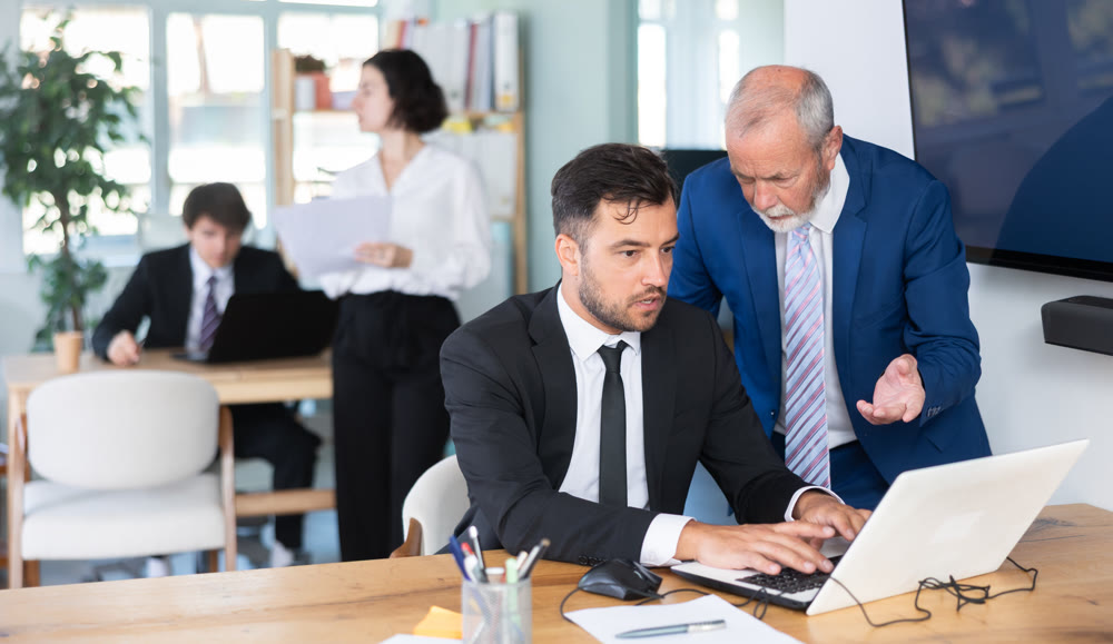 Experienced office employee explains work tasks
