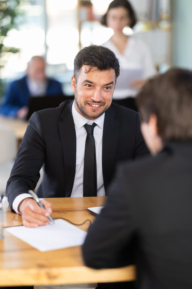 Consultant of a modern bank office tells a man about deposits and savings accounts
