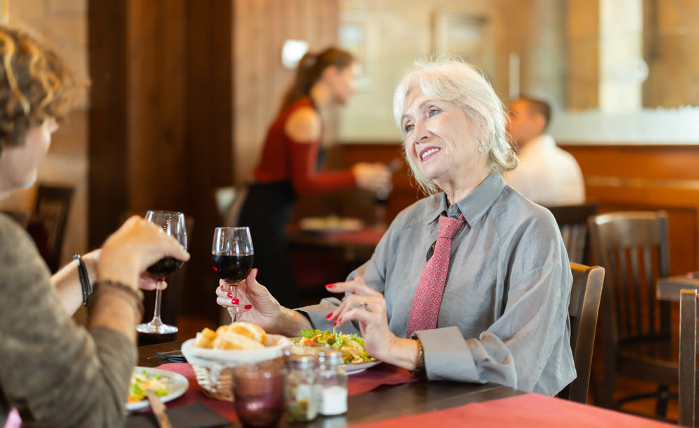 Couple elderly woman and adult man in restaurant