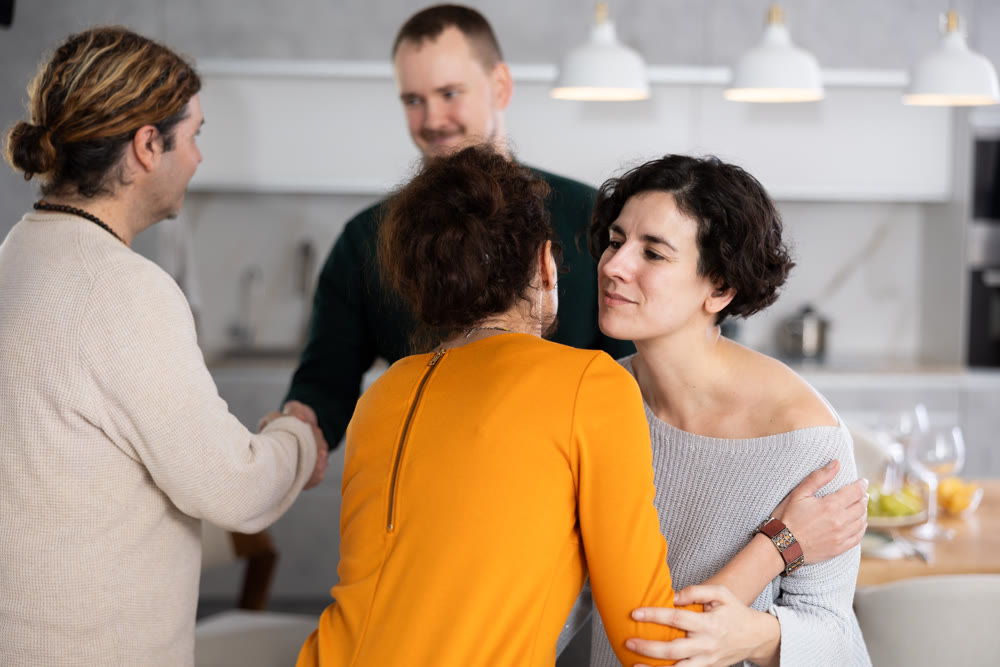 After chatting and gatherings, women friends hug and kiss goodbye.