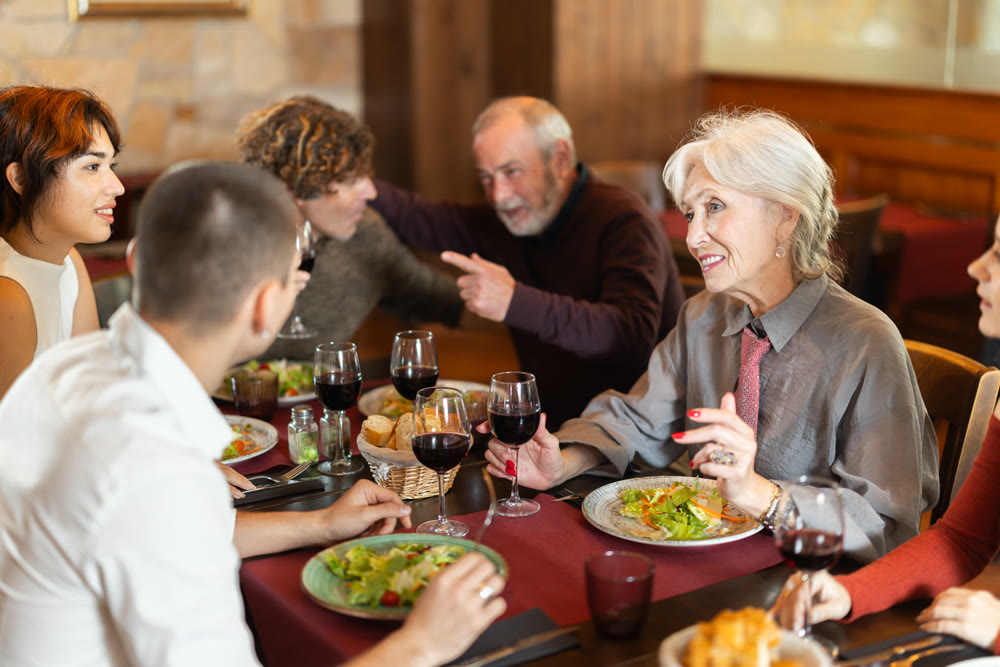 Family having dinner and talking in restaurant