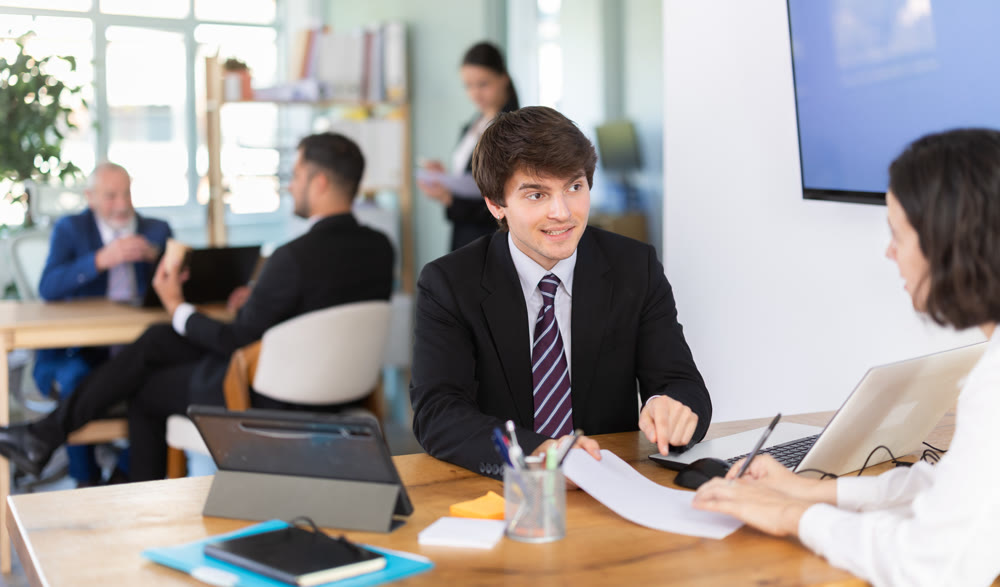 Bank manager talking with female client in office