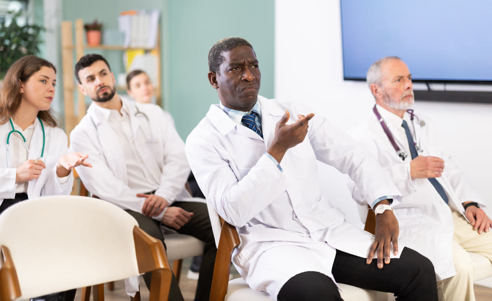 African doctor at a conference listens attentively to a lecture