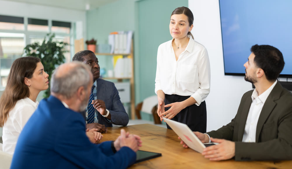 Adult woman leading meeting at office table