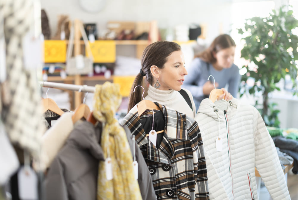 Adult woman chooses outerwear in store