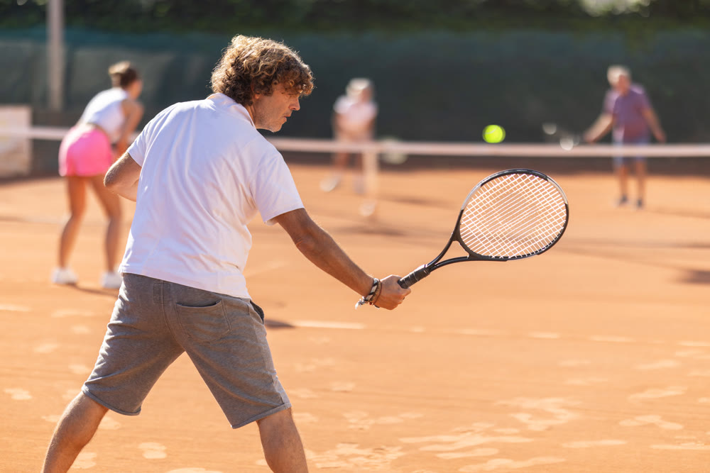 woman plays tennis with a fly woman