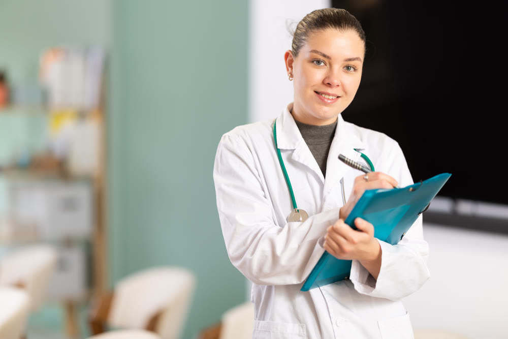 Young female doctor with folder invites in lecture hall