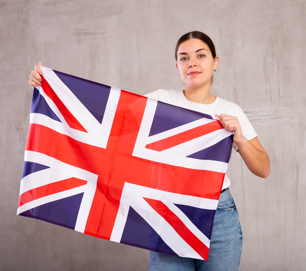 Attractive female football fan holding Great Britain flag