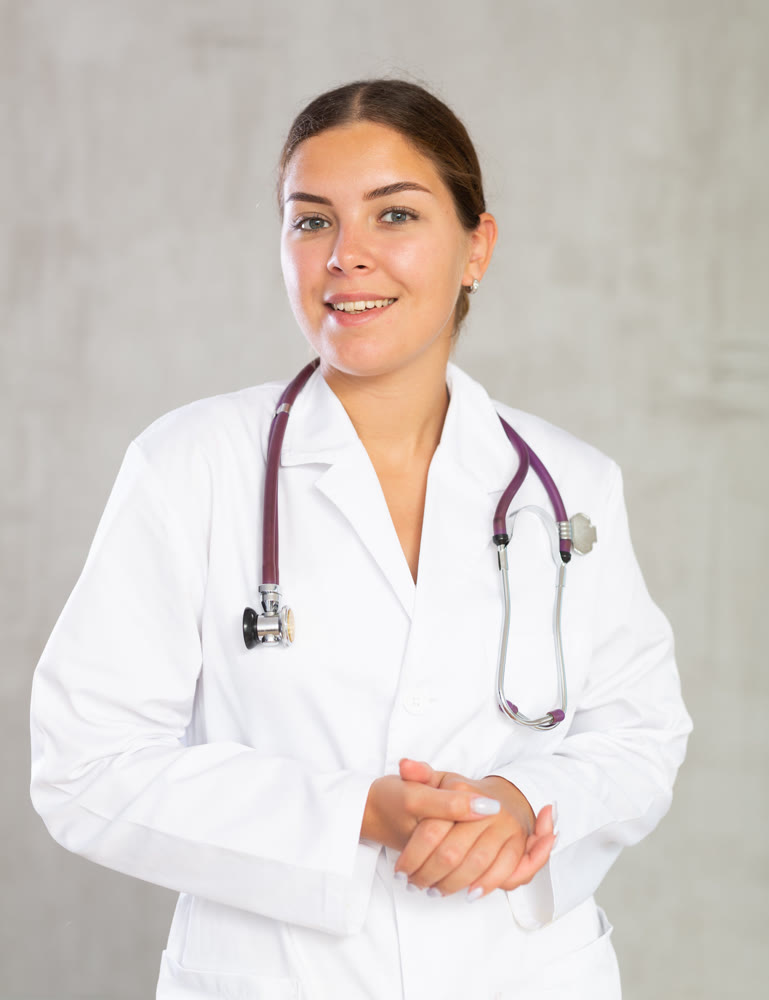 Young woman posing in medical uniform in studio