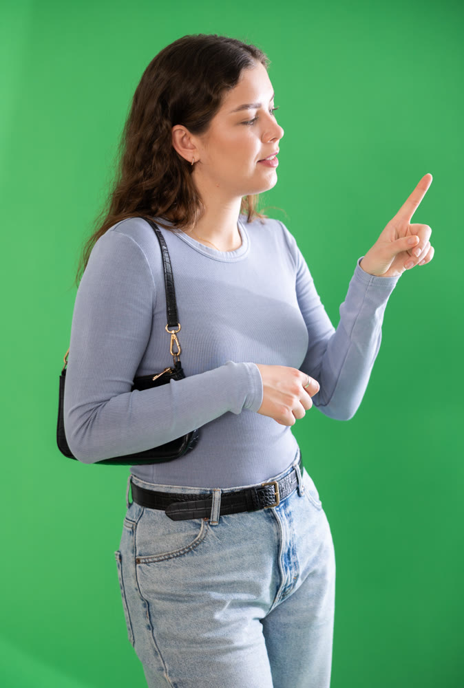 Young woman moves her finger across virtual screen