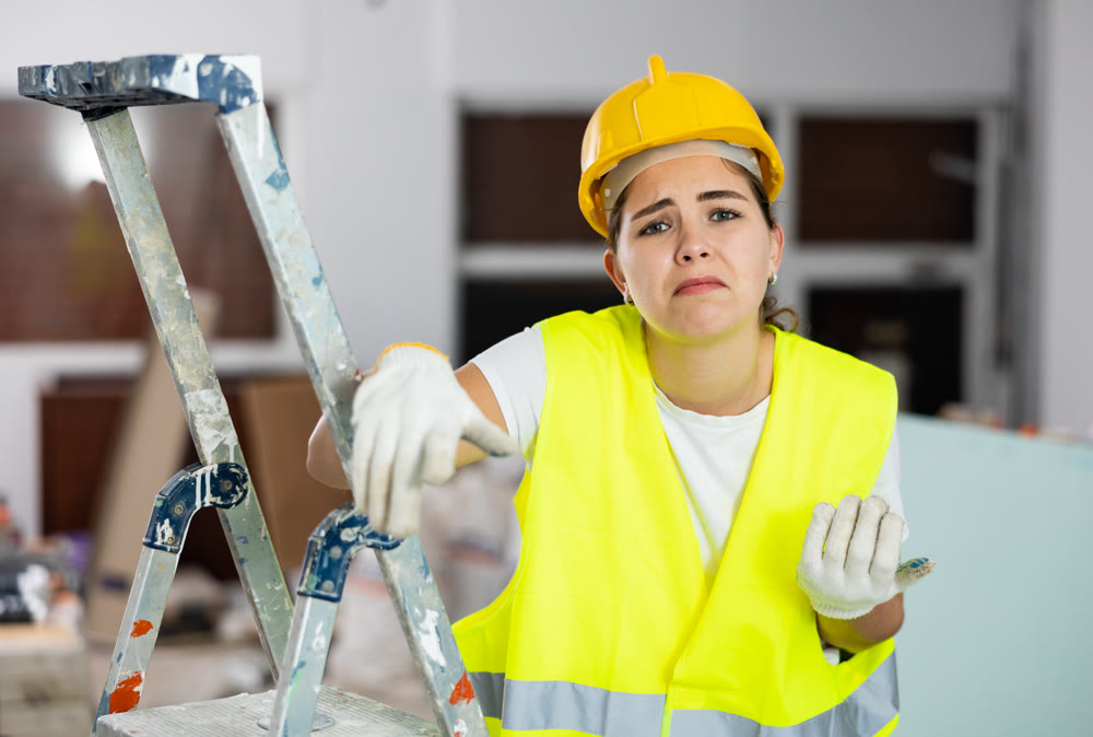 Puzzled confused female civil engineer inside building under construction