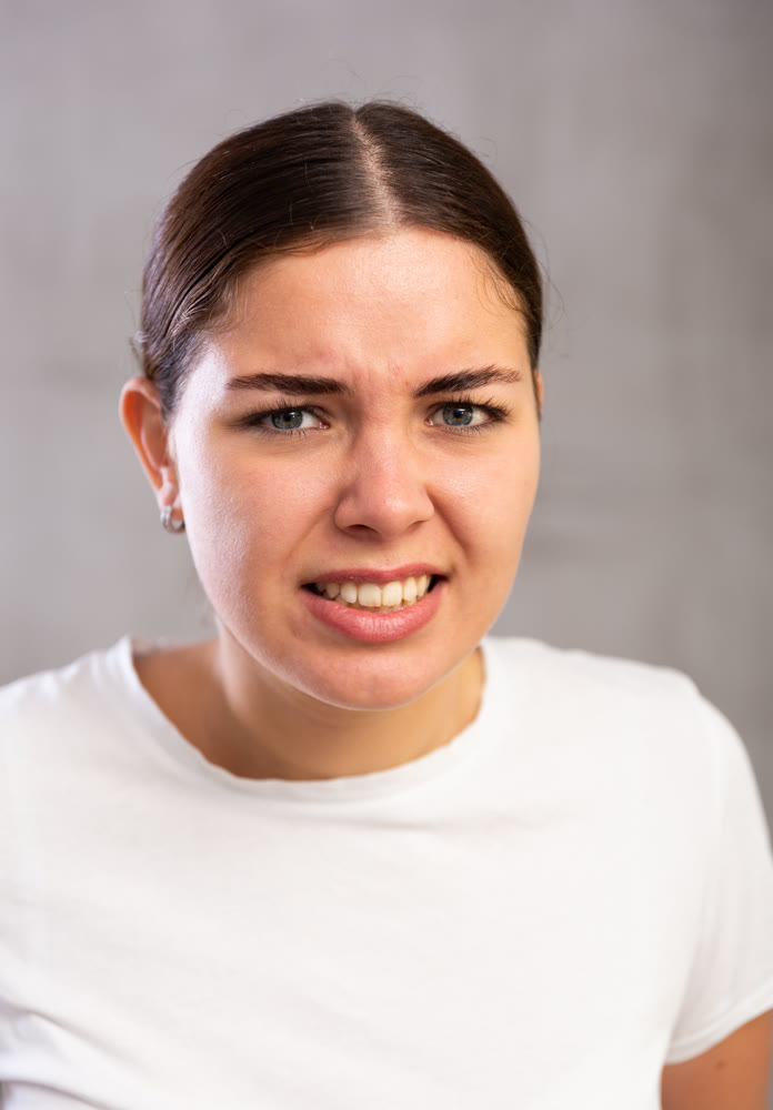 Portrait of indignant young woman in t-shirt