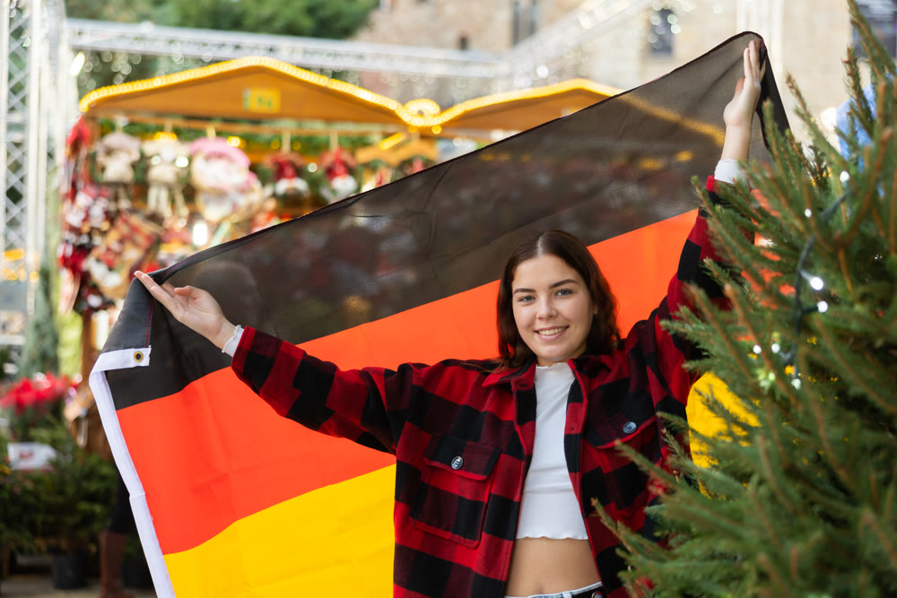 Girl with Germany flag at new year street fair