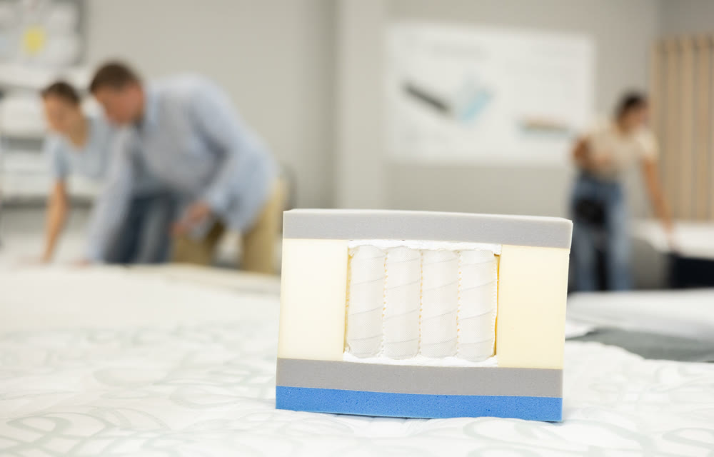 Pocket independent spring sewn in white span-bond in store. Sample of spring mattress filler in store