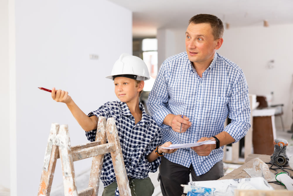 Father with little son talking about repair work in the apartment