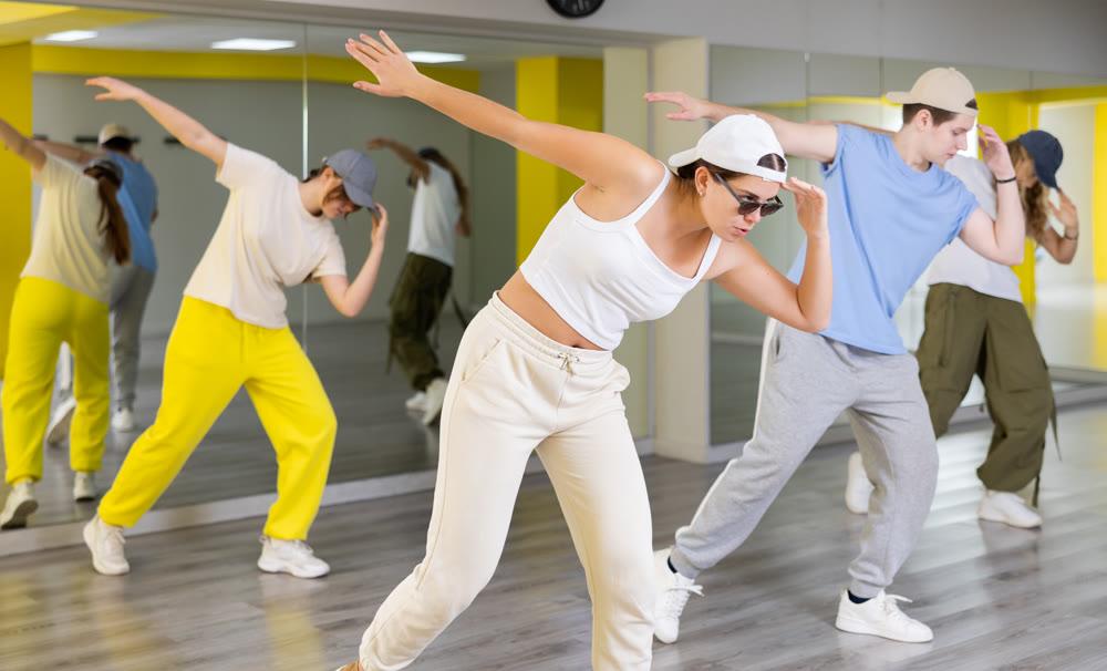 Boys and girls performing contemporary dance in studio.