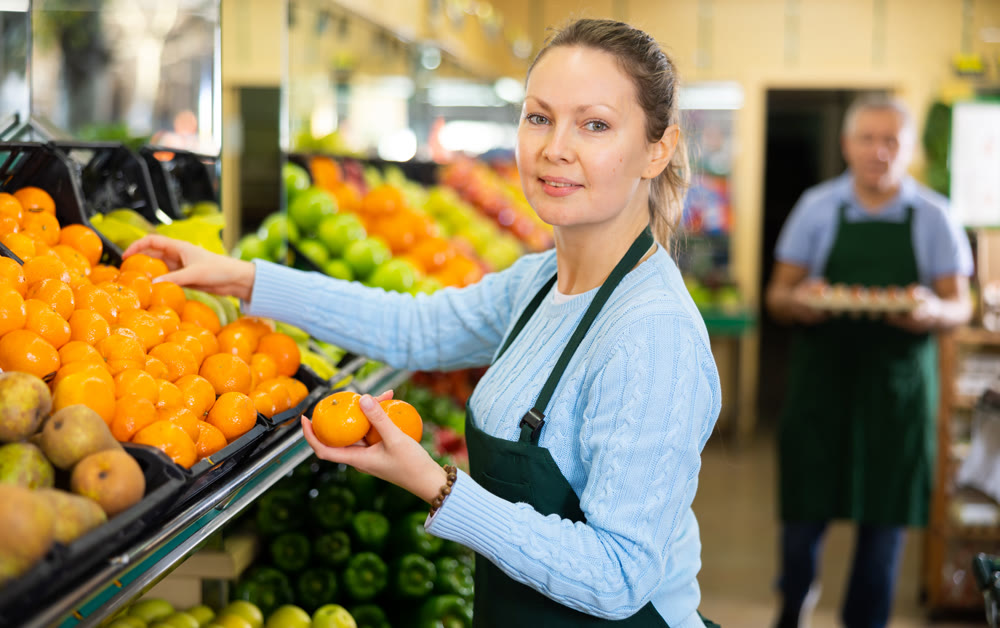 woman seller offers to buy tangerines