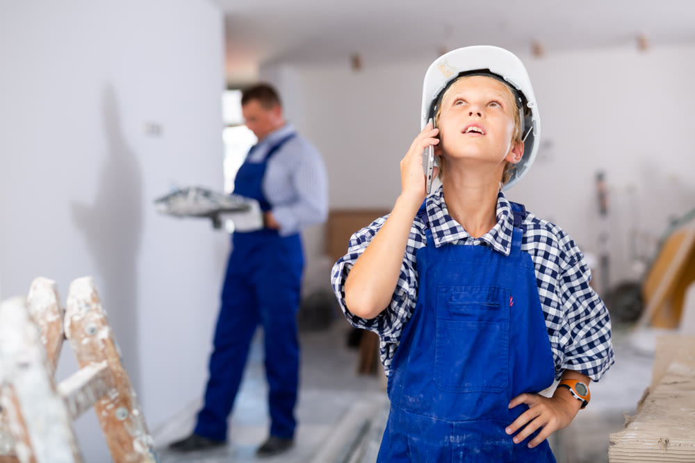 Portrait of boy in overall talking on phone