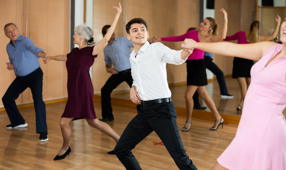 Young pair practicing ballroom dance in dance studio