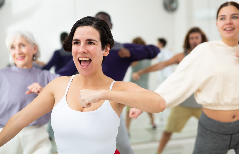 Emotional Latina learning moves of lezginka during group class