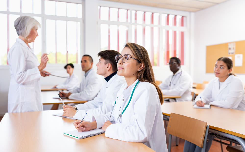 Portrait of doctors different age who writing exercises at lesson
